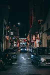 grey vehicle parked near white concrete building